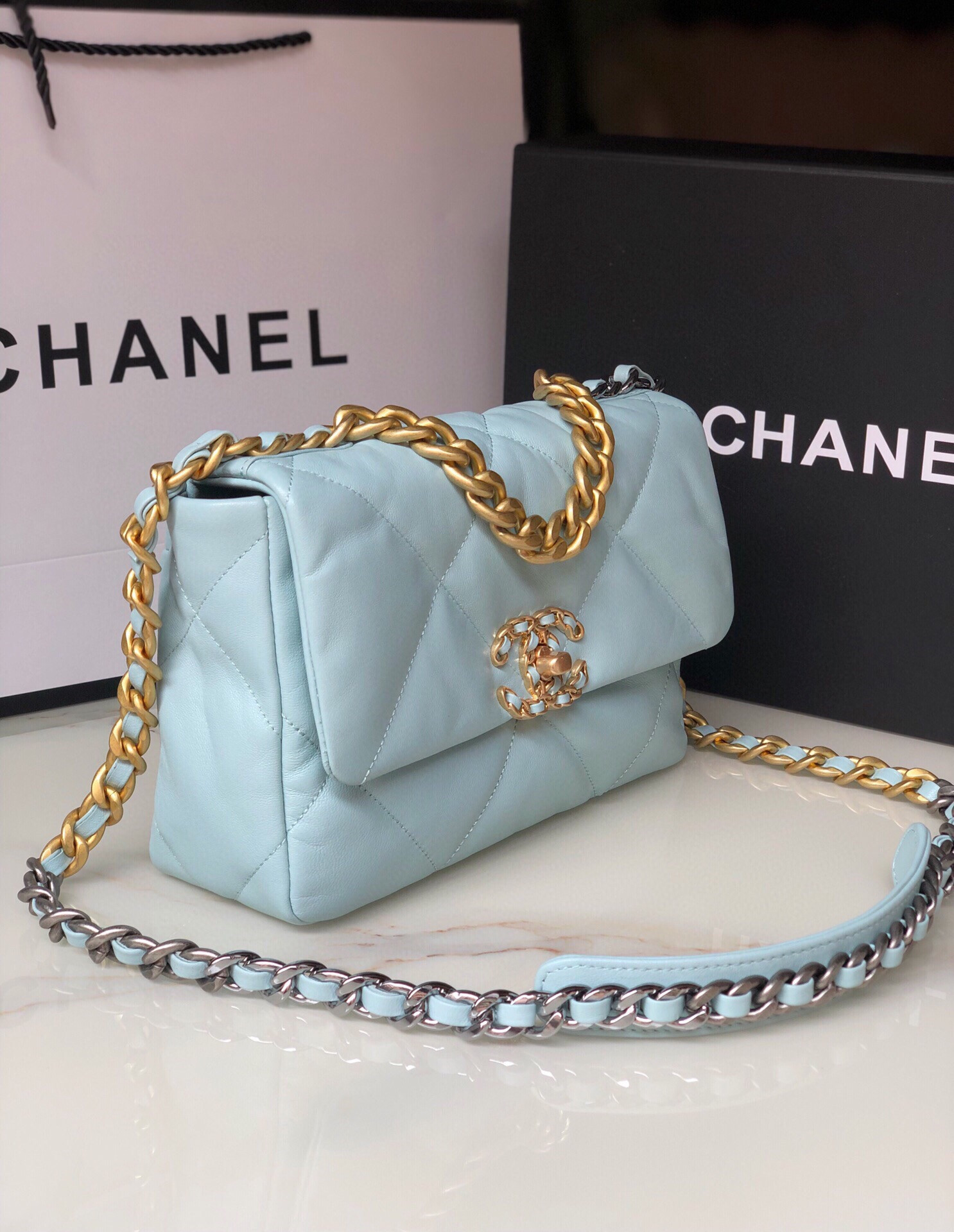 Ch*el 19 handbag shiny leather, gold-tone, silver-tone & ruthenium-finish metal light blue 6.2 × 10.1 × 3.5 in