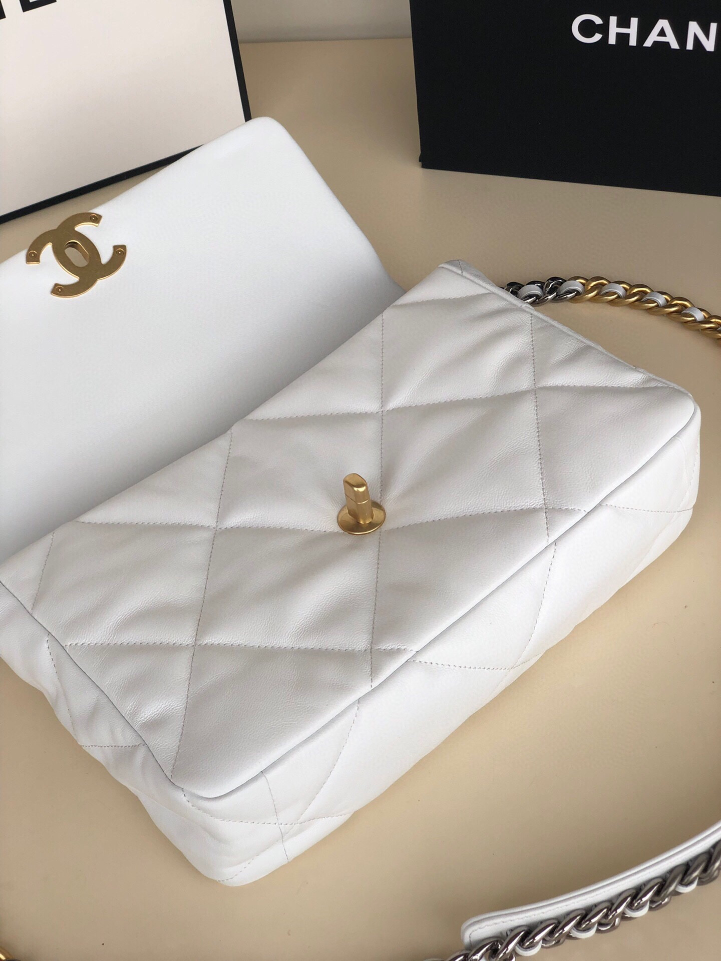 Ch*el 19 large handbag shiny leather, gold-tone, silver-tone & ruthenium-finish metal white 7.8 × 11.7 × 3.9 in