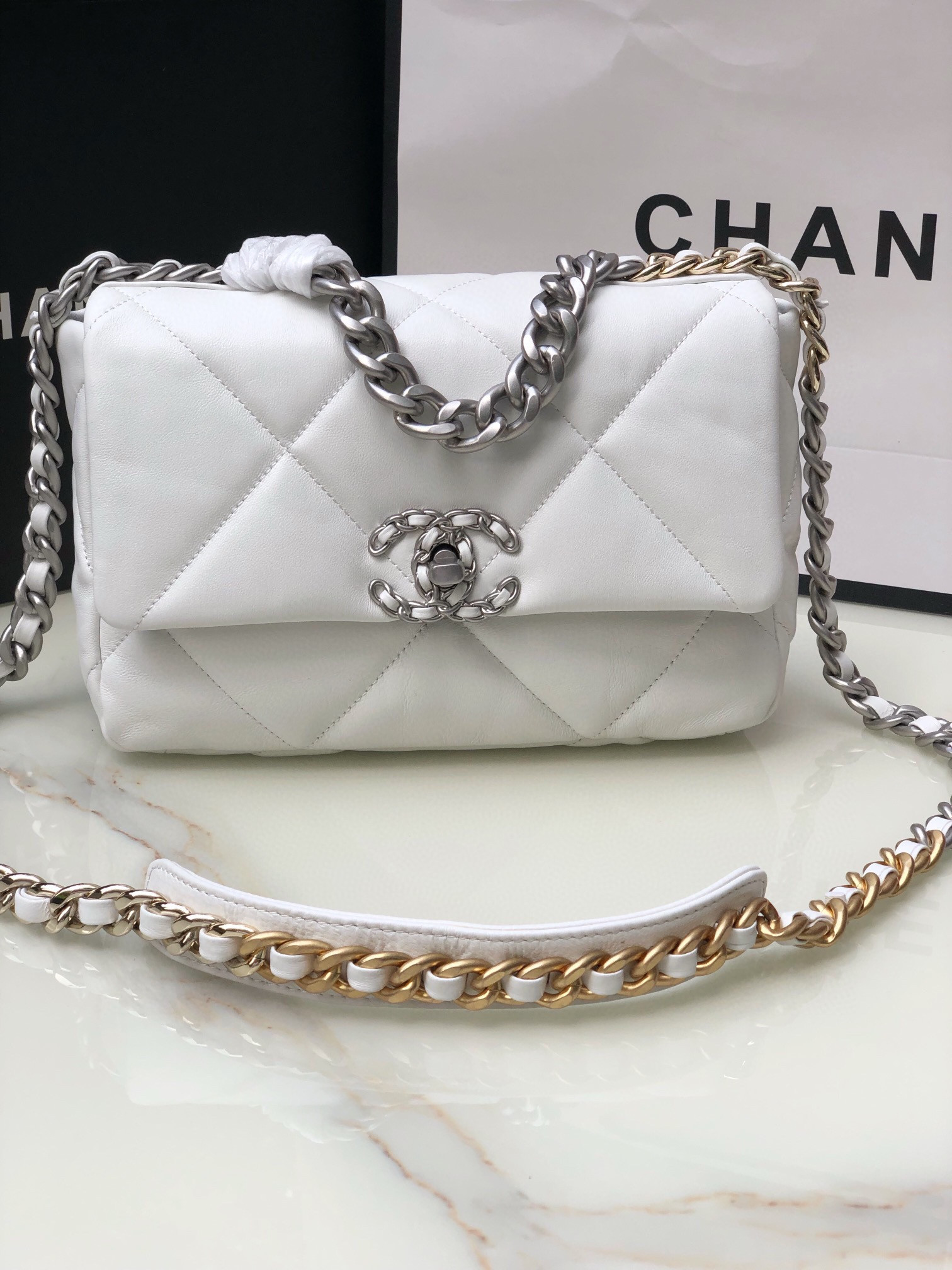 Ch**el 19 HANDBAG Shiny Leather, Gold-Tone, Silver-Tone & Ruthenium-Finish Metal White 6.2 × 10.1 × 3.5 in